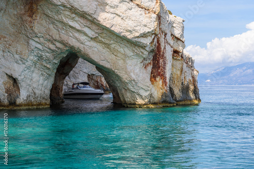 Famous Blue Caves and cruise boat near Skinari Cape. Zakynthos Island, Greece.