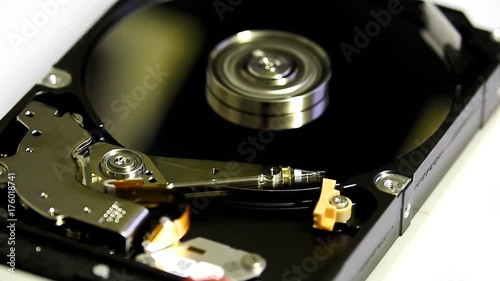 An opened Hard Drive that has failed with Spinning Disks and Head Reader
