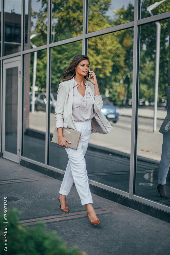 Series of a business woman in the city. Beautiful brunette sitting in coffee shop and working on com Series of a business woman in the city. Beautiful brunette sitting in coffee shop and working on com