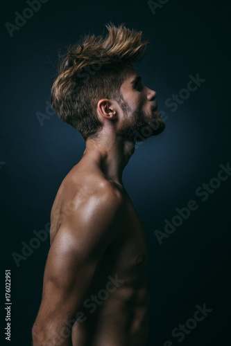Muscular Shirtless Man in Dark Background