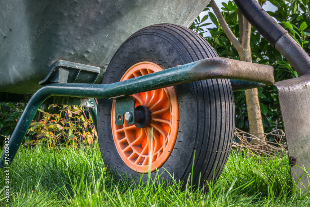 Fototapeta premium a wheelbarrow and a spade in the garden