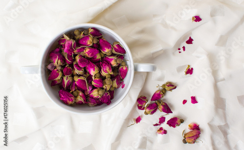 Small rose tea flowers in a cup photo