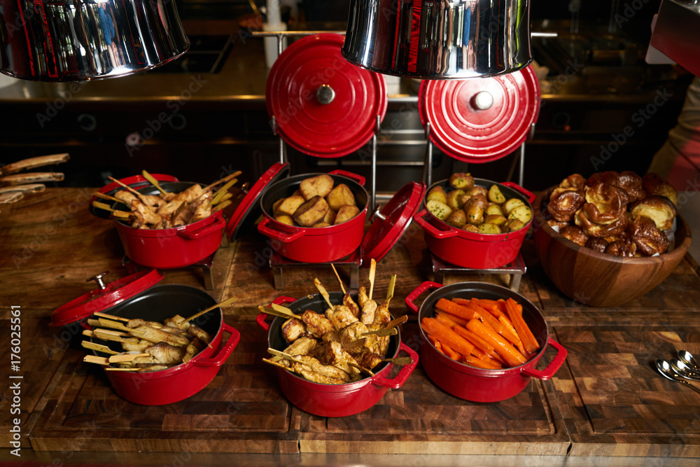 Big dish set with boiled carrots, baked potatoes, fried fish