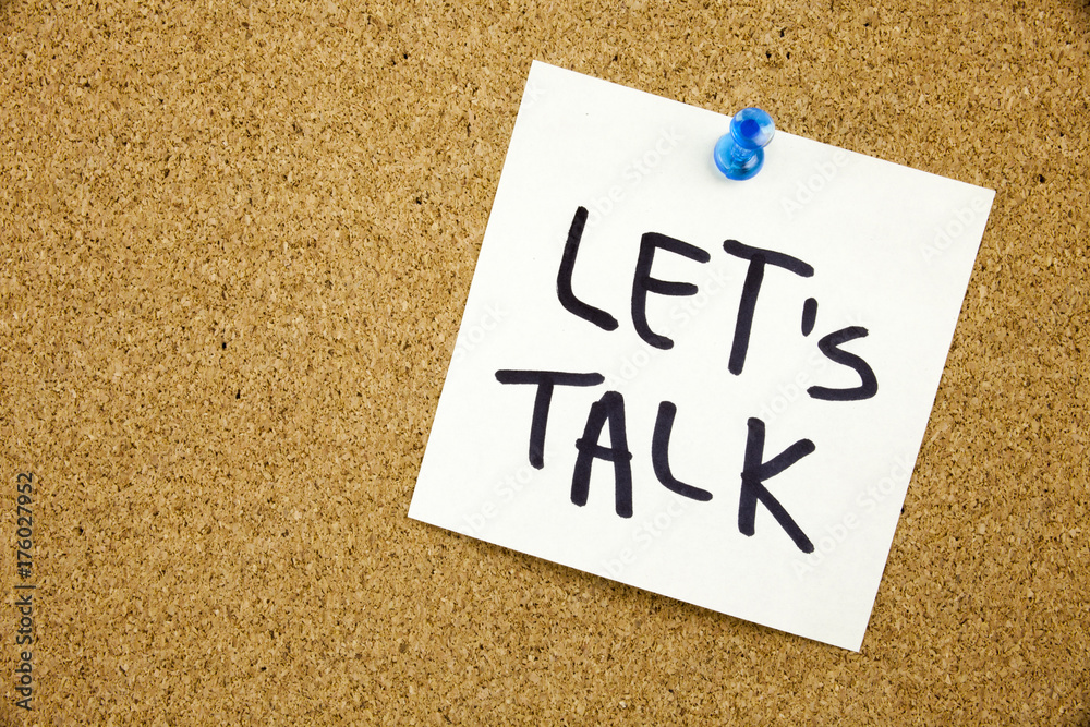 A yellow sticky note writing, caption, inscription Phrase LET'S TALK in black ext on a sticky note pinned to a cork notice board A yellow sticky note writing, caption, inscription Phrase LET'S TALK in black ext on a sticky note pinned to a cork notice board