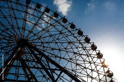 Part of ferris wheel silhouette during sunset. photo