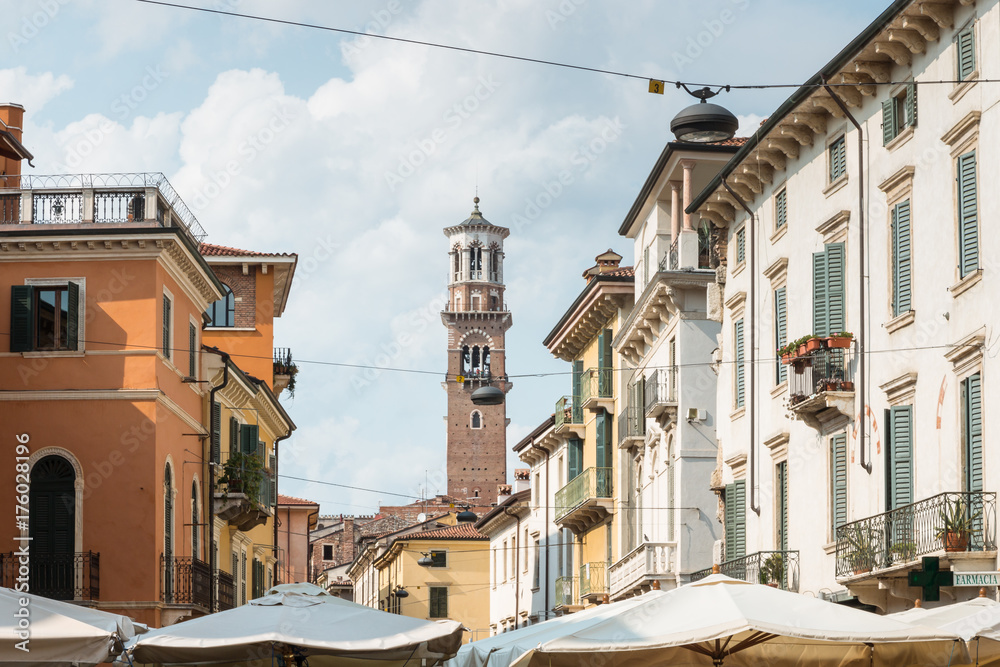 old street with historic houses and Lamberti tower in Verona, Italy