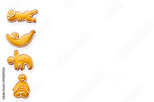 Gingerbread cookies in shape of yoga asanas on white background top view copyspace
