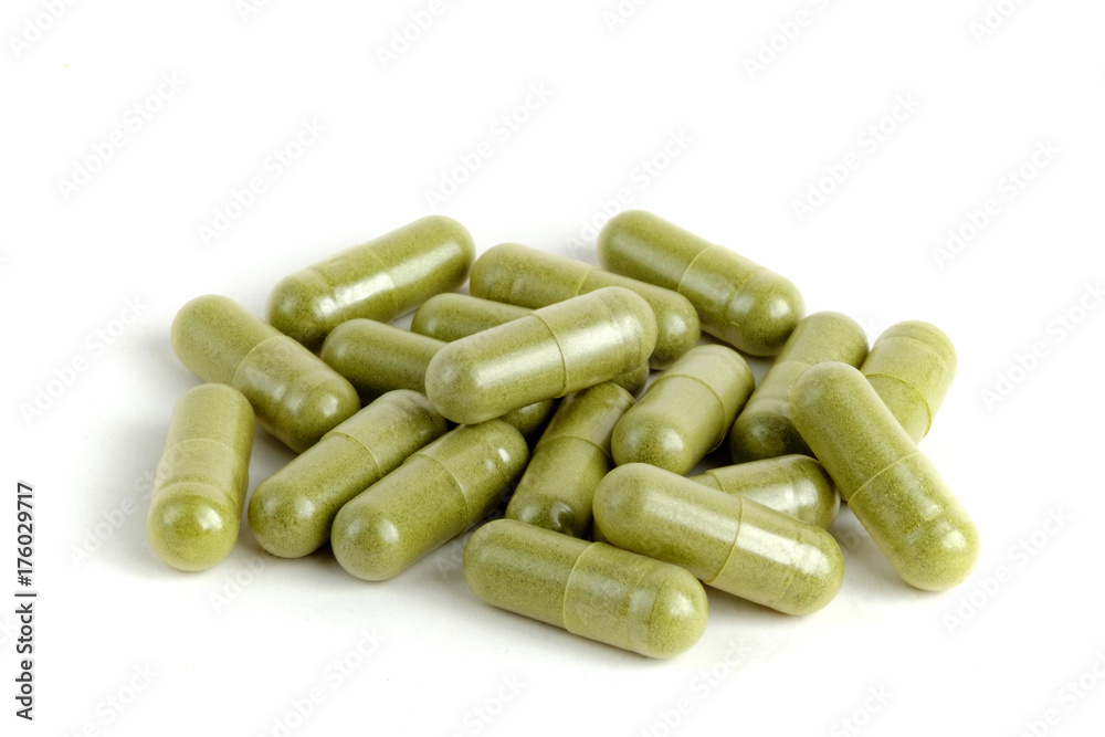 Moringa capsules on white background Moringa capsules on white background