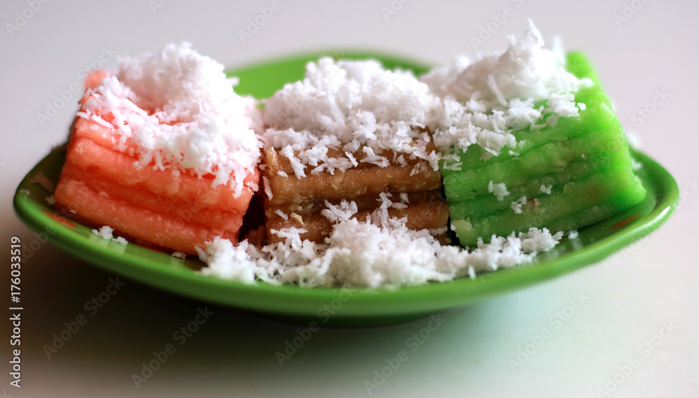 Getuk lindri. Indonesian traditional food.Steam cassava cake sprinkled with coconut Getuk lindri. Indonesian traditional food.Steam cassava cake sprinkled with coconut