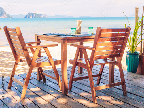 Dinner table on the beach with beautiful sea view background. © Siam