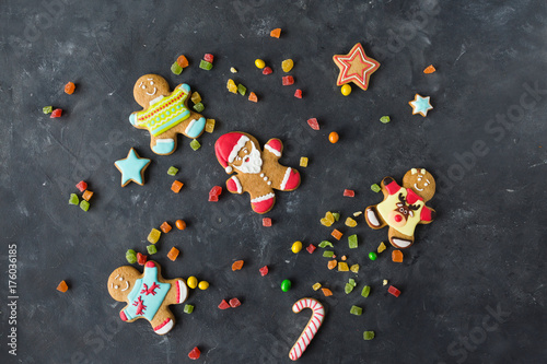 Ginger men with colored glaze on a gray background .. Gingerbread. Christmas cookies. Ginger man in a colored sweater