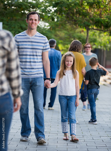 Loving father walks with a cheerful girl