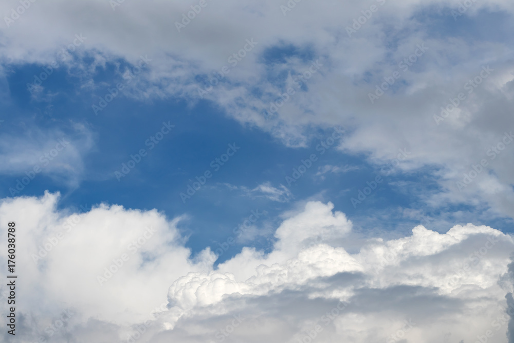 A group of fluffy white clouds and cloudy sky.