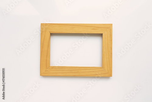 Wooden rectangular photo frame on white background. Close-up. Top view. Nobody, empty