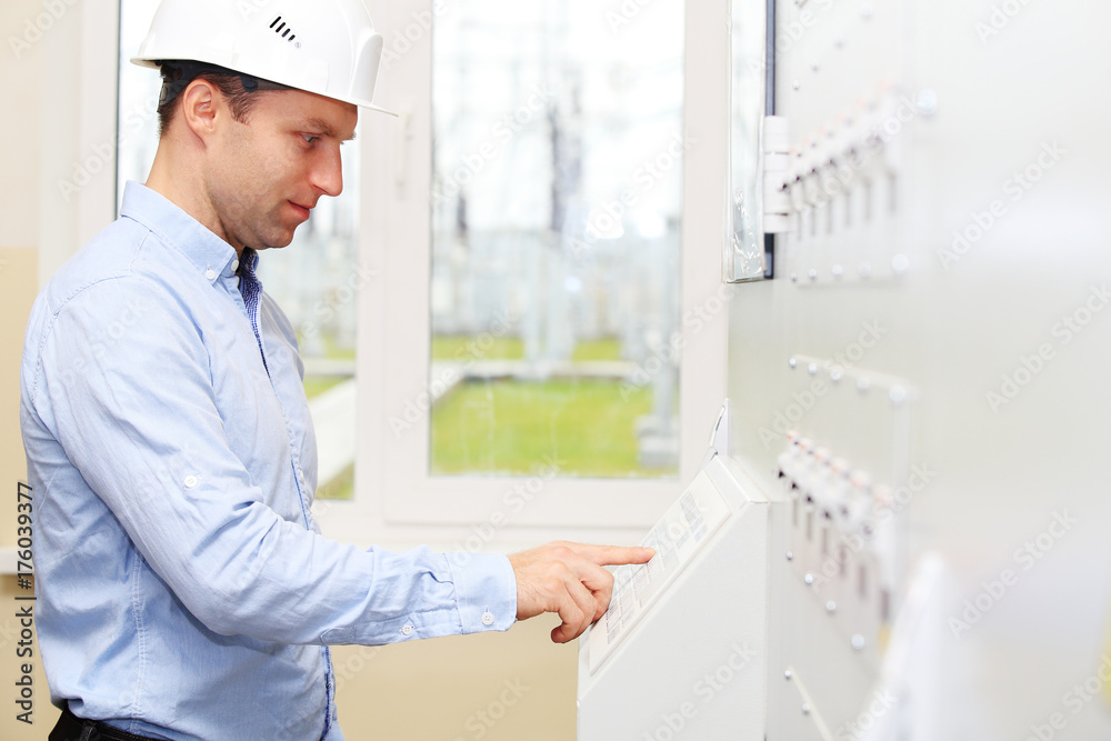 Engineer checking energy system parameters Engineer checking energy system parameters