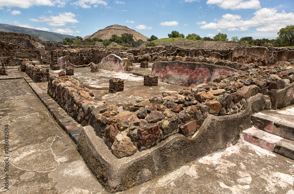 Teotihuacan, Mexico: ancient Aztec ruin structures with the Pyramid of the Sun in the background at the Teotihucan archaeologic site