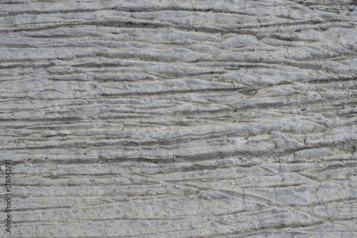 Textured concrete surface material with specific patterns.