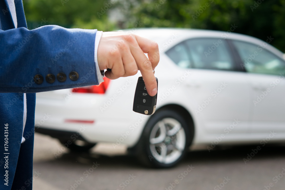 car key in hands on white auto background