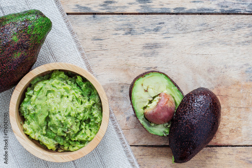 Grated avocado on wooden.