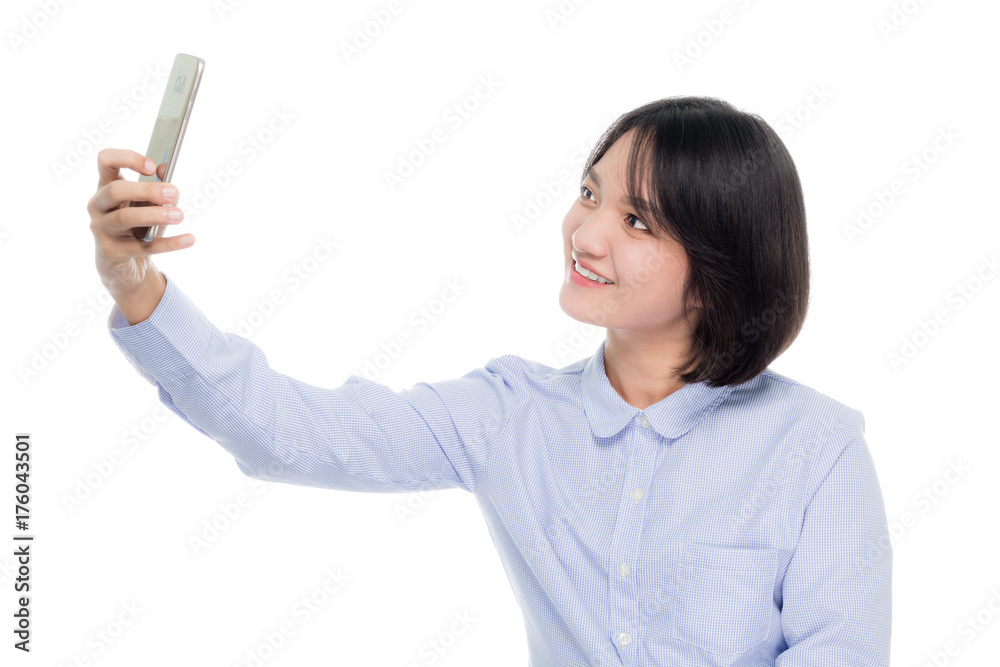 Portrait of a beautiful asian business woman taking a selfie photo with smart phone. Isolated on white background Portrait of a beautiful asian business woman taking a selfie photo with smart phone. Isolated on white background