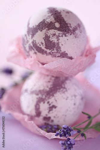 Lavender bath bombs. bomb for a bath with lavender extract on a gentle lilac background and lavender flowers. organic natural cosmetics concept