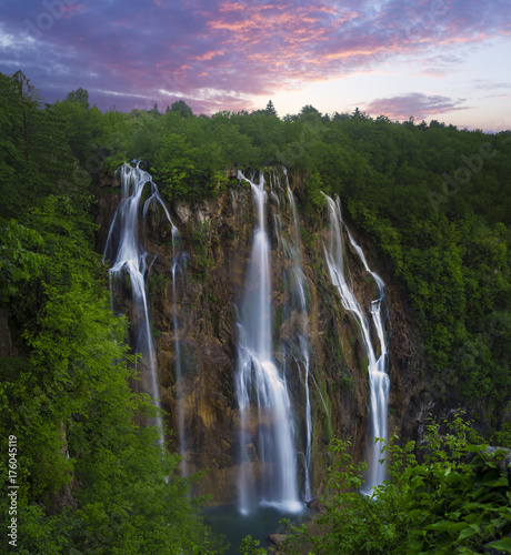 foggy and multicolored dawn over beautiful waterfalls in the park of plitvice lakes in croatia