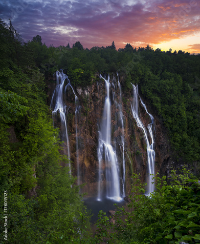 foggy and multicolored dawn over beautiful waterfalls in the park of plitvice lakes in croatia