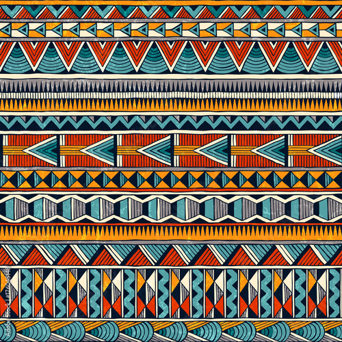 Tribal seamless ornament in vibrant colours. Abstract background in african style. Hand drawn vector illustration EPS 10.