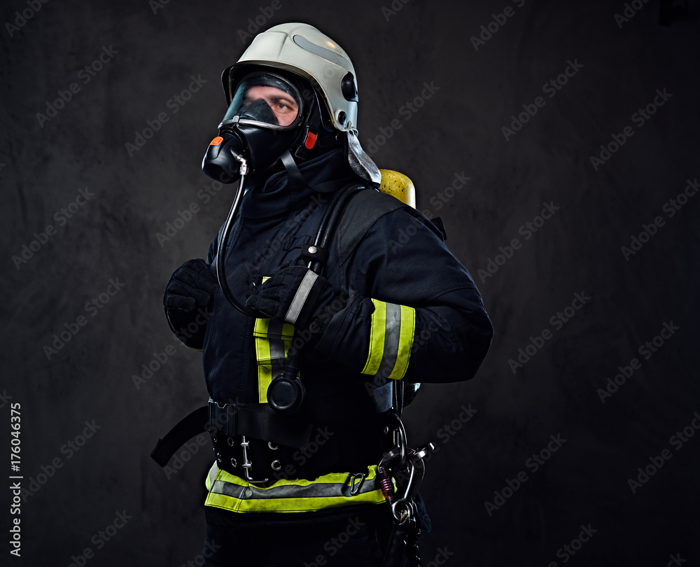 Firefighter dressed in uniform and an oxygen mask.