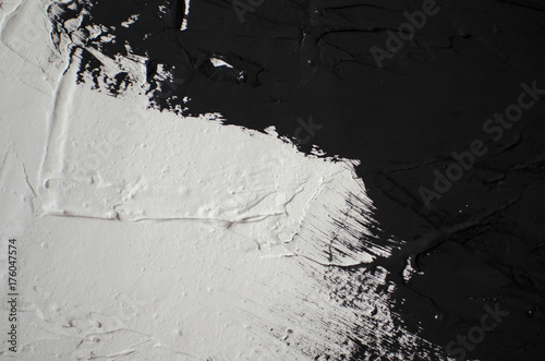 Black and white textured background. Black paint on the white free designed wall