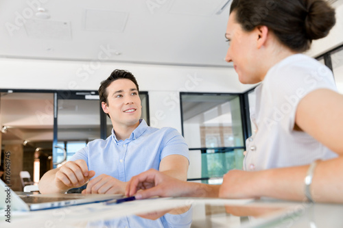 Image of two young business people in office