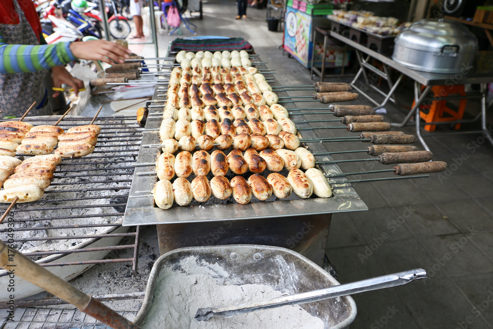 Local seller make Roasted Pisang Awak banana at Sriyan market, Bangkok, Thailand