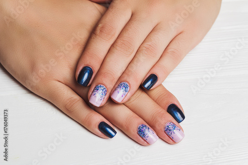 Festive nail art in navy blue and light purple colors with tinsels