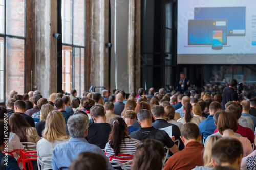 Audience listens to the lecturer at the conference hall