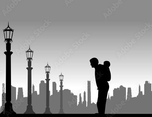 Father carrying a child piggyback on the street, one in the series of similar images silhouette