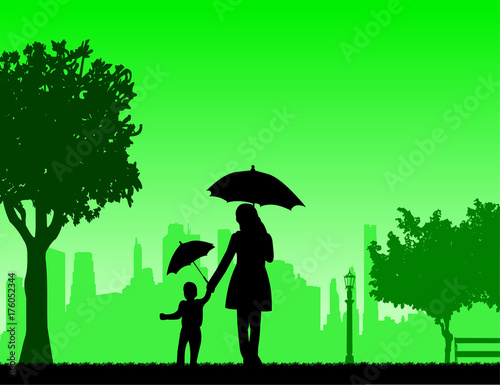 Mother walking under the umbrellas with her child in park  one in the series of similar images silhouette