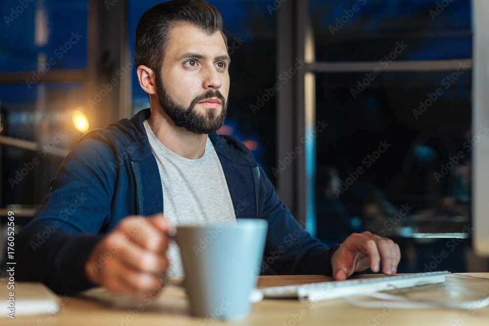 Handsome bearded man working at night Handsome bearded man working at night