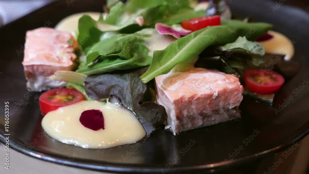 Grilled fresh salmon steaks salad in black plate, the healthy fish cuisine Grilled fresh salmon steaks salad in black plate, the healthy fish cuisine