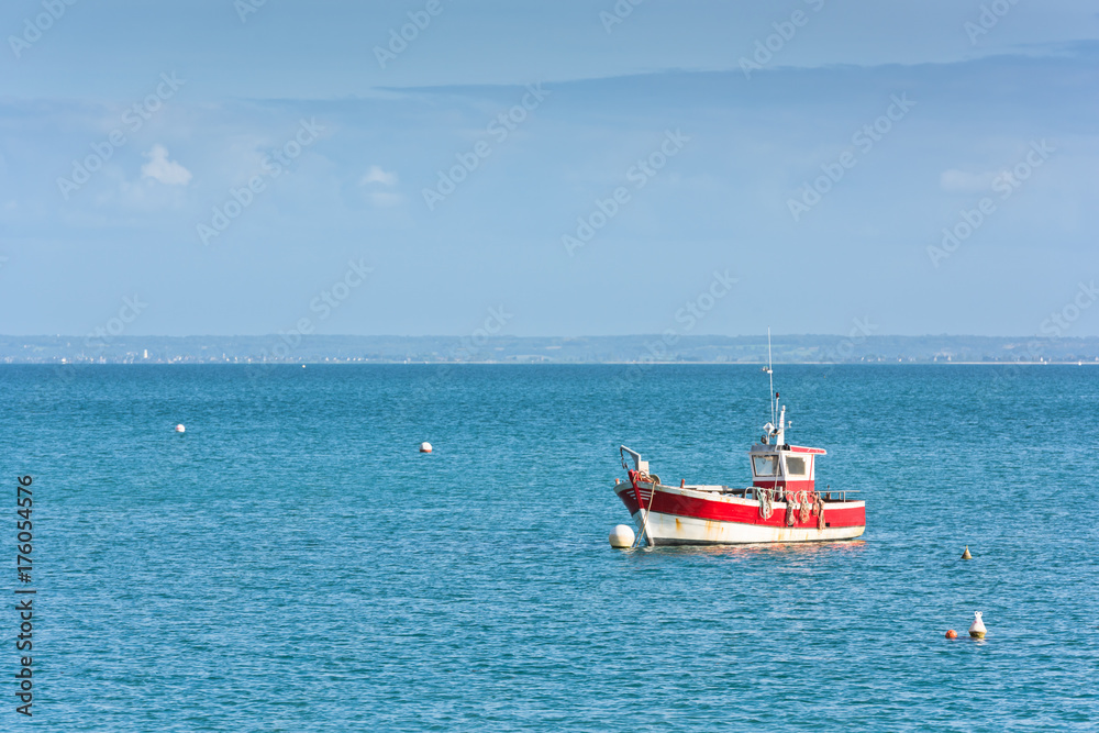 Bright blue sea and a fisherman boat