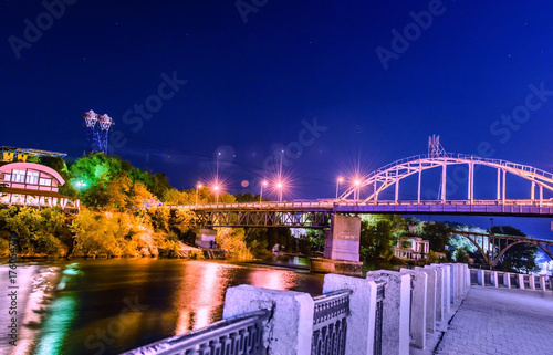Beautiful Night view of an Artificial Waterfall and footbridge on Monastyrsky Island in the city of Dnepr on the river.. Dnepropetrovsk, Dnipropetrovsk, Dnipro city, Ukraine photo