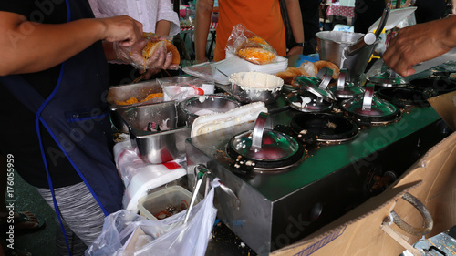 Local seller make Thai pancake with shredded young coconut, Kanom Tang Taek at local shop at Sriyan market, Bangkok, Thailand