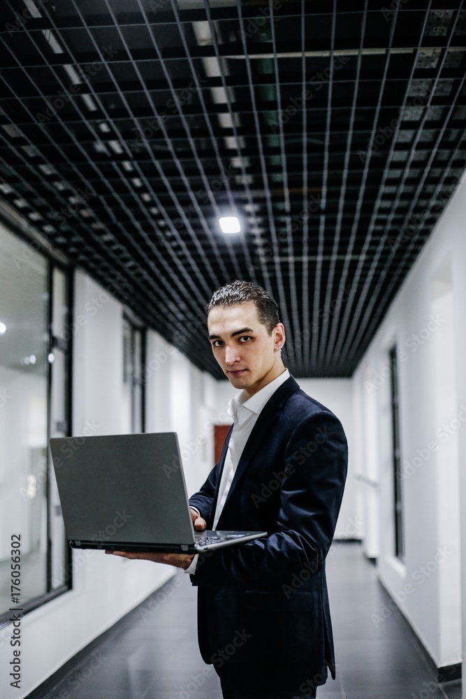 Young businessman in suit with laptop Young businessman in suit with laptop