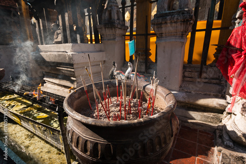Incense sticks in pots to hallow of  Wat Phra That Lampang Luang in Thailand
