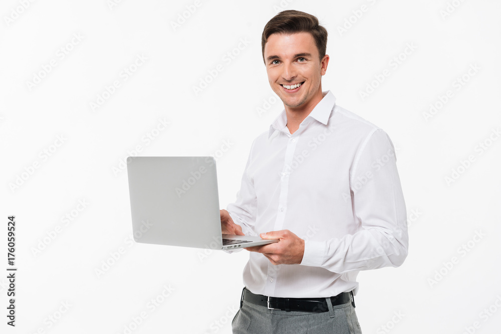 Portrait of a happy young man holding laptop computer Portrait of a happy young man holding laptop computer