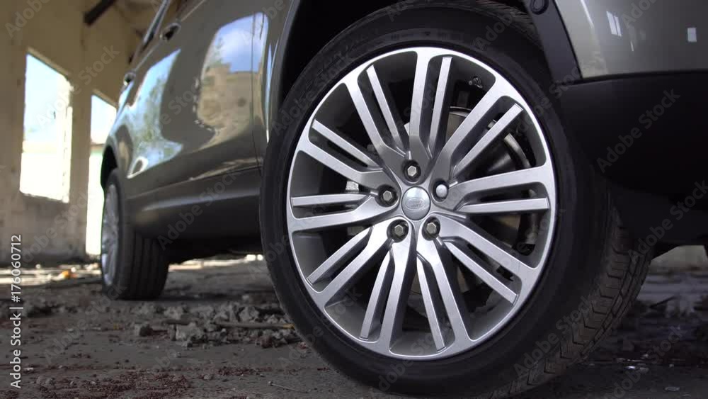 Close up detail view of modern parked car chrome rimmed wheel. Panning effect. Close up detail view of modern parked car chrome rimmed wheel. Panning effect.