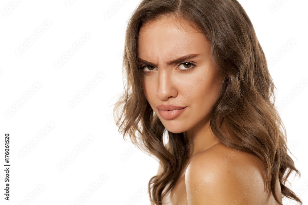 Portrait of beautiful young scowling woman on white background Portrait of beautiful young scowling woman on white background