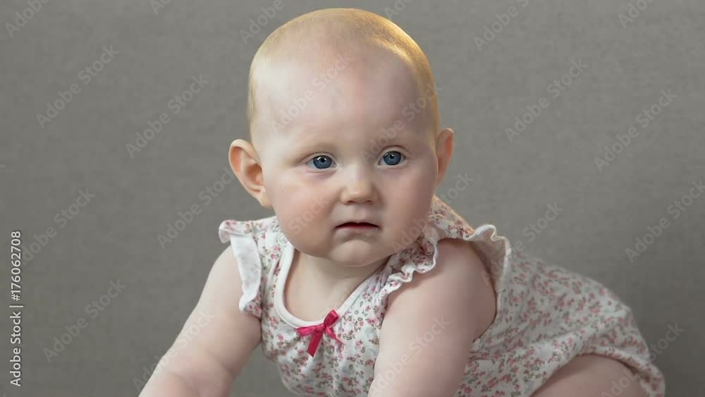 Small child jumping on all four on couch, turning suddenly serious, mood change