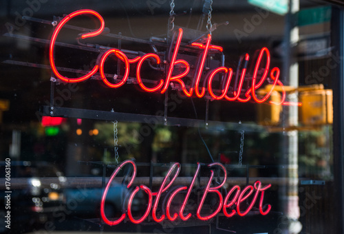 Cocktails and cold beer neon sign in the window of a bar
