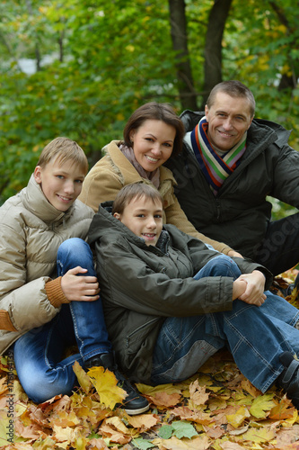 Happy smiling family sitting on leaves © aletia2011