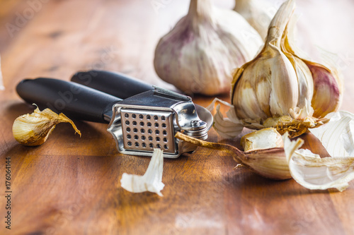 Fresh garlic and garlic presser.